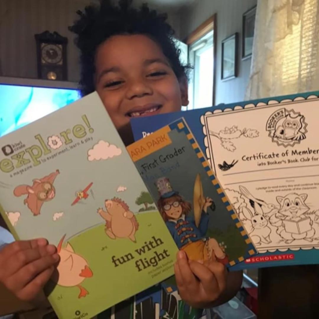 Young boy receives book pack